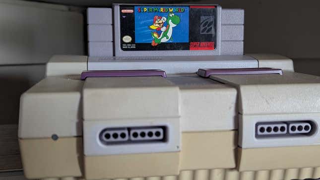 An old SNES sits on a shelf. 